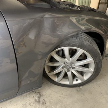 photo of a car with a big dent